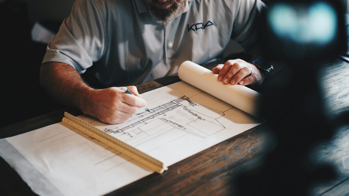 Master craftsman shaping solid timber chair frame